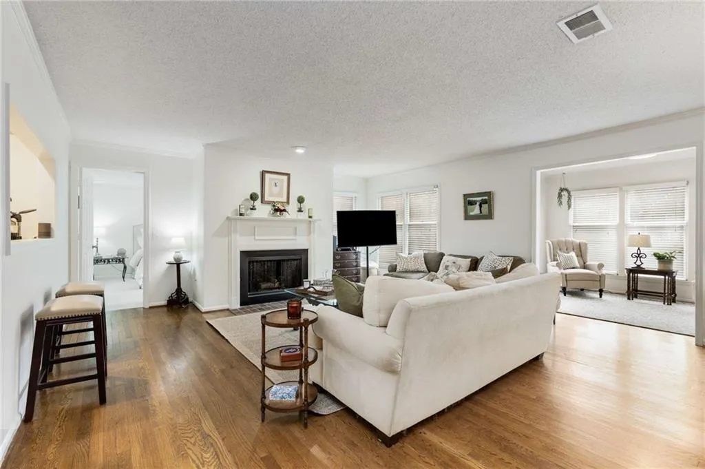 This thoughtfully updated home is nestled in a serene & picturesque community. Notice the rich & flawless hardwood floors that extend into the living & dining rooms & into the sunroom.