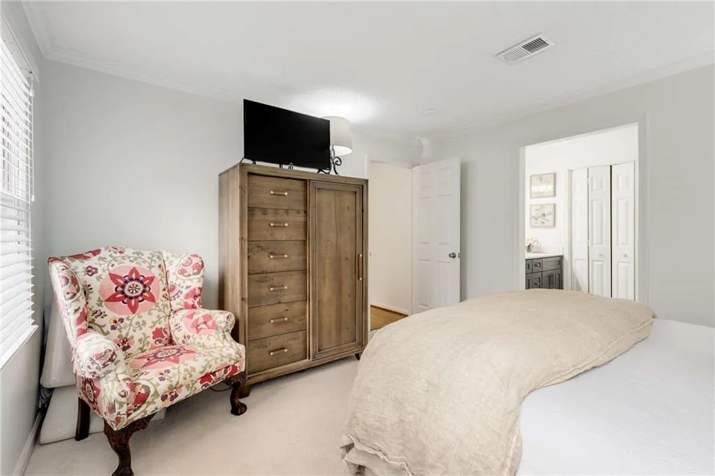 Another view of the generous primary en suite that features new plush carpeting, a walk-in closet & full bath.