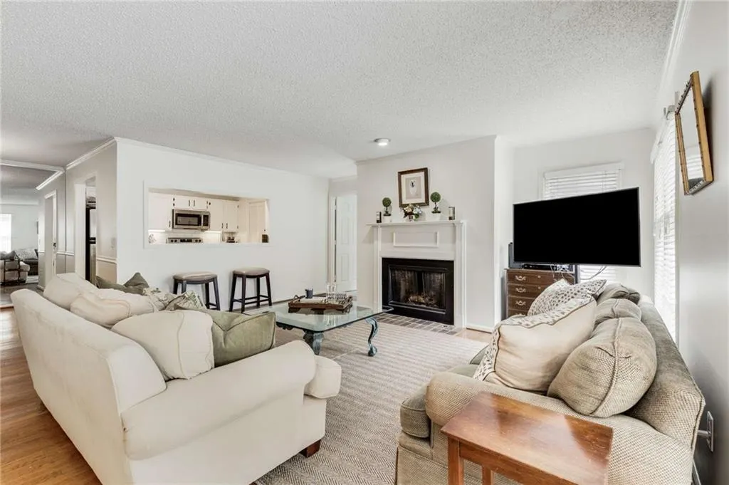 The open fireside living room. Notice the pass through window/breakfast bar.