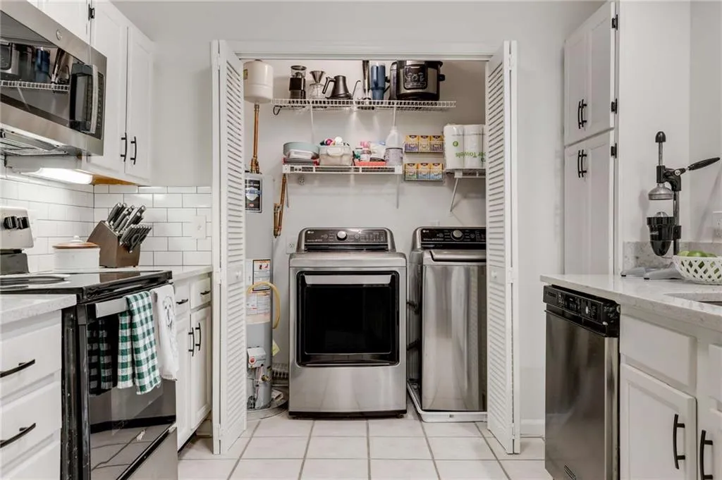 The laundry closet is located in the kitchen & features shelving for products/storage.
