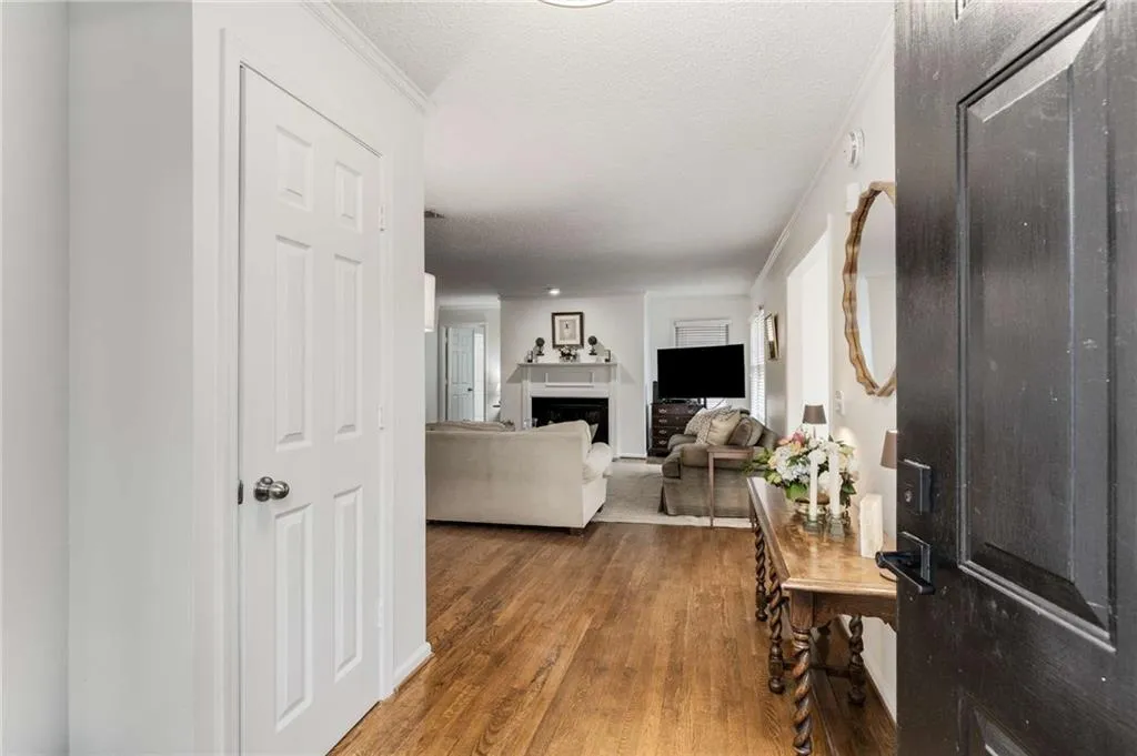 Step inside this updated home to discover rich hardwood floors that gracefully extend through the living & dining rooms & into the sun-drenched sunroom!