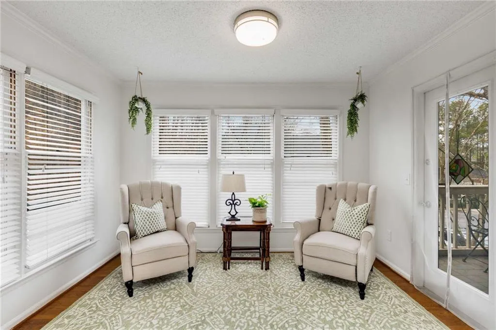 The sun-drenched sunroom. This western facing unit boasts an abundance of windows that bathe the home in natural light each afternoon.