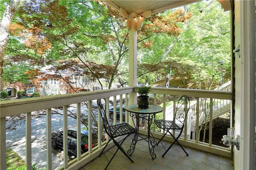 View of your private 2nd floor terrace that is framed by lush tree coverage, ensuring privacy and creating an exquisite setting for a al fresco dining! It also overlooks the serene landscaped grounds of Heritage Oaks.