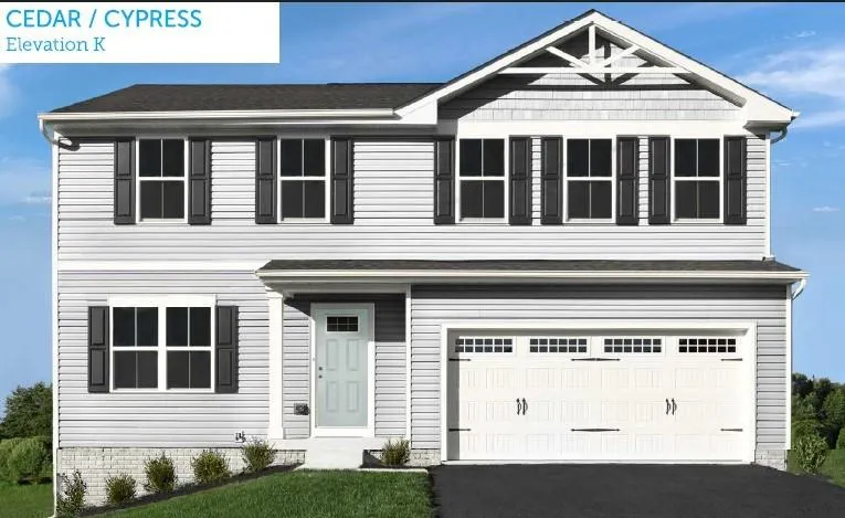 Two-story residence featuring light gray siding, white trim, and a prominent gable with decorative accents