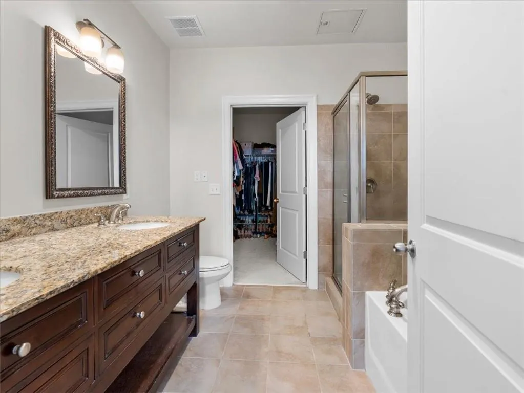 ensuite with dual vanity and large walk-in closet