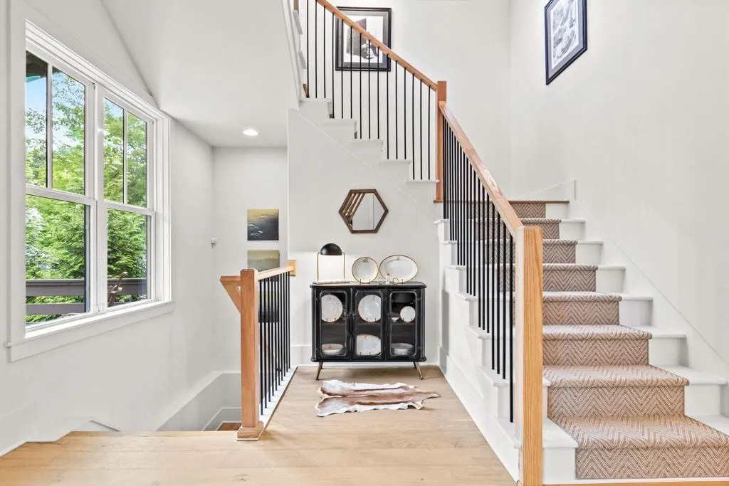 Staircase featuring wood finished floors and recessed lighting