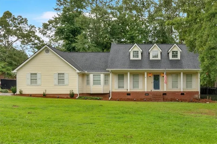 Cape cod-style house featuring crawl space, a front yard, and roof with shingles