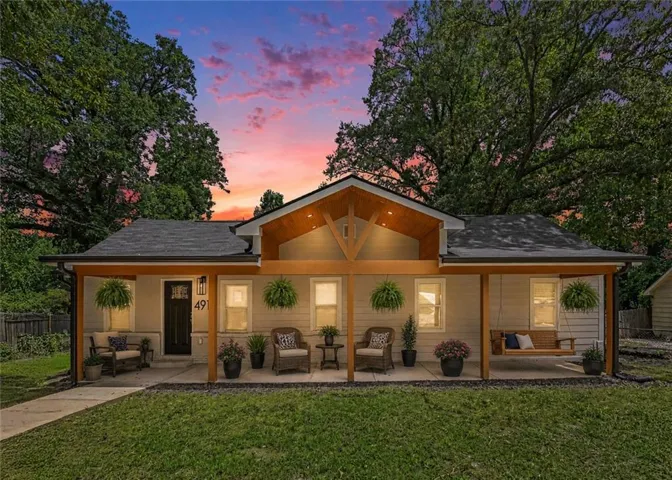 Front exterior featuring a covered porch with exposed wood beams