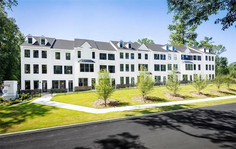 Contemporary townhome exteriors featuring white siding and black window shutters