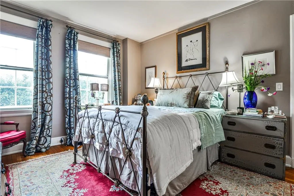 Bedroom featuring wood finished floors and crown molding