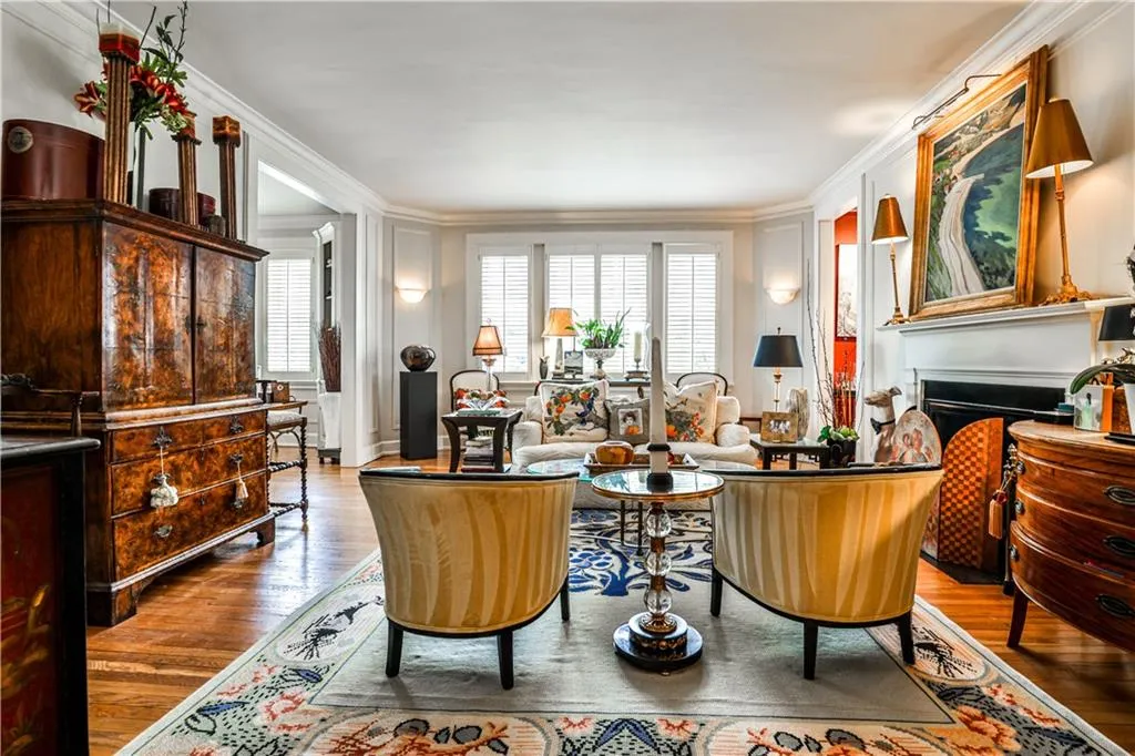 Living area with crown molding, a fireplace, and wood finished floors