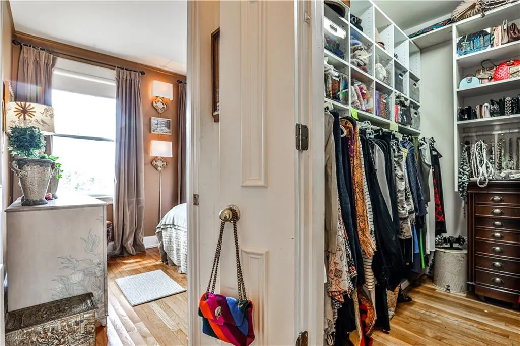 Walk in closet with light wood-style floors
