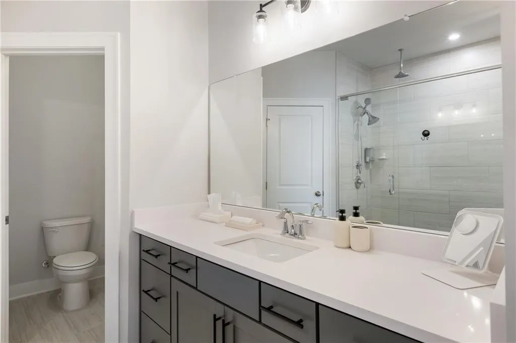 Full bathroom with vanity and a stall shower