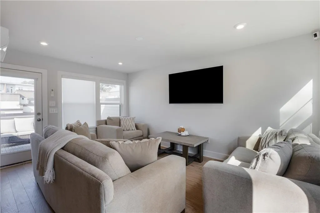 Living area with recessed lighting and wood finished floors
