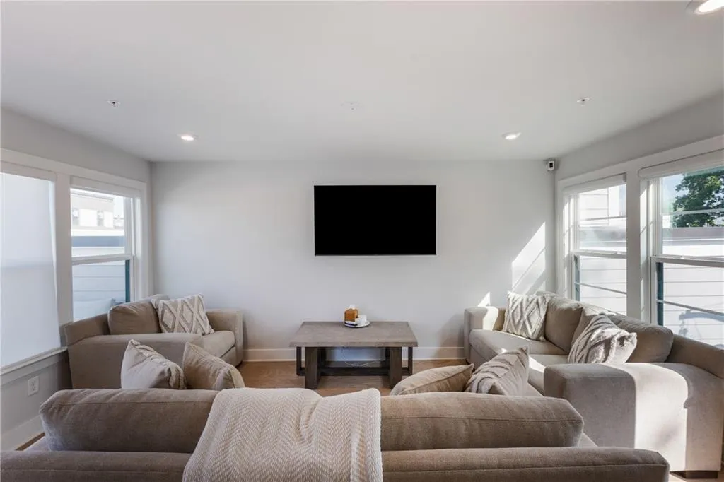 Living area with plenty of natural light and recessed lighting