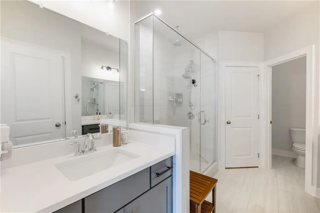 Full bath with a stall shower and vanity