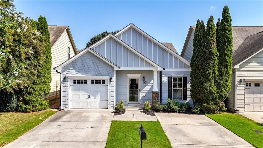 Single-story residence featuring a one-car garage, light blue siding, decorative black shutters, and an inviting front porch