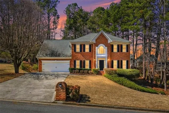 Brick exterior with a white two-car garage