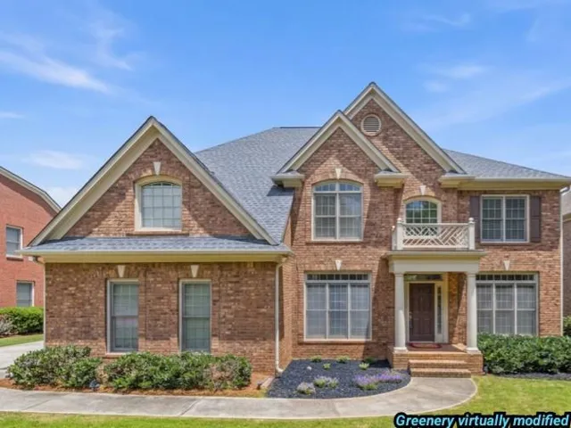 Brick exterior featuring a gabled roofline and contrasting trim
