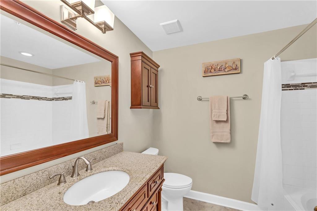 Bathtub/shower combo  and tile flooring