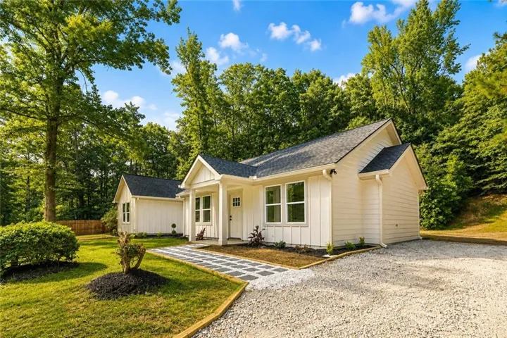 White siding exterior with a dark shingled roof