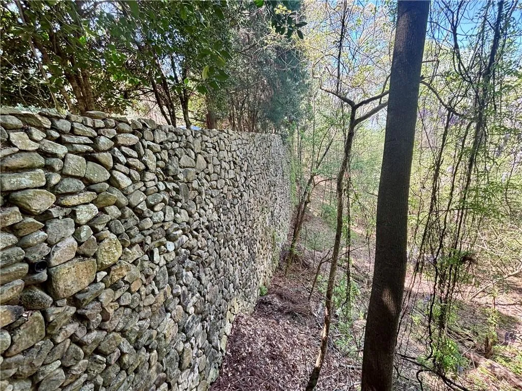 Millions spent on retaining walls, ready to be incorporated into outdoor plans.- picture your sports courts, outdoor living, barn... 15+ acres to enjoy.