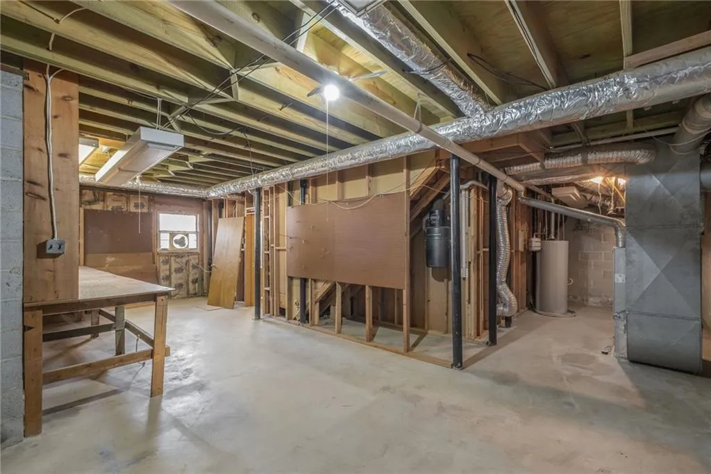Basement featuring heating unit and gas water heater