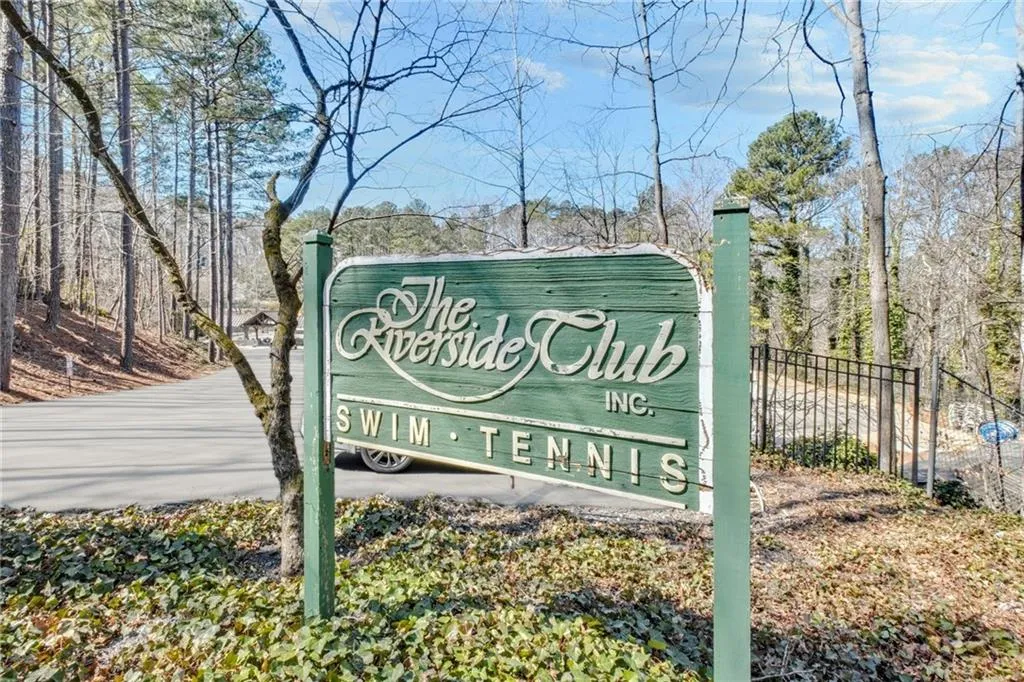 Community / neighborhood sign featuring fence