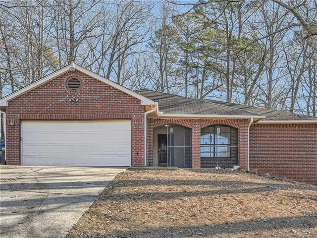 Red brick exterior with a two-car garage