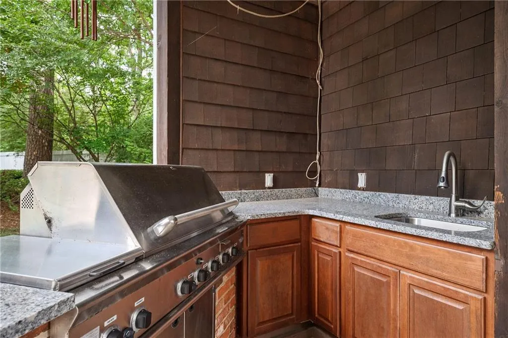 Outdoor kitchen with gas grill and sink