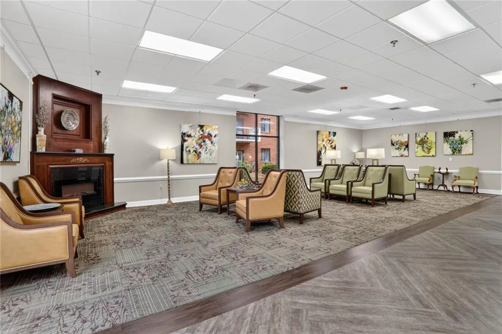 Common area with a paneled ceiling and crown molding