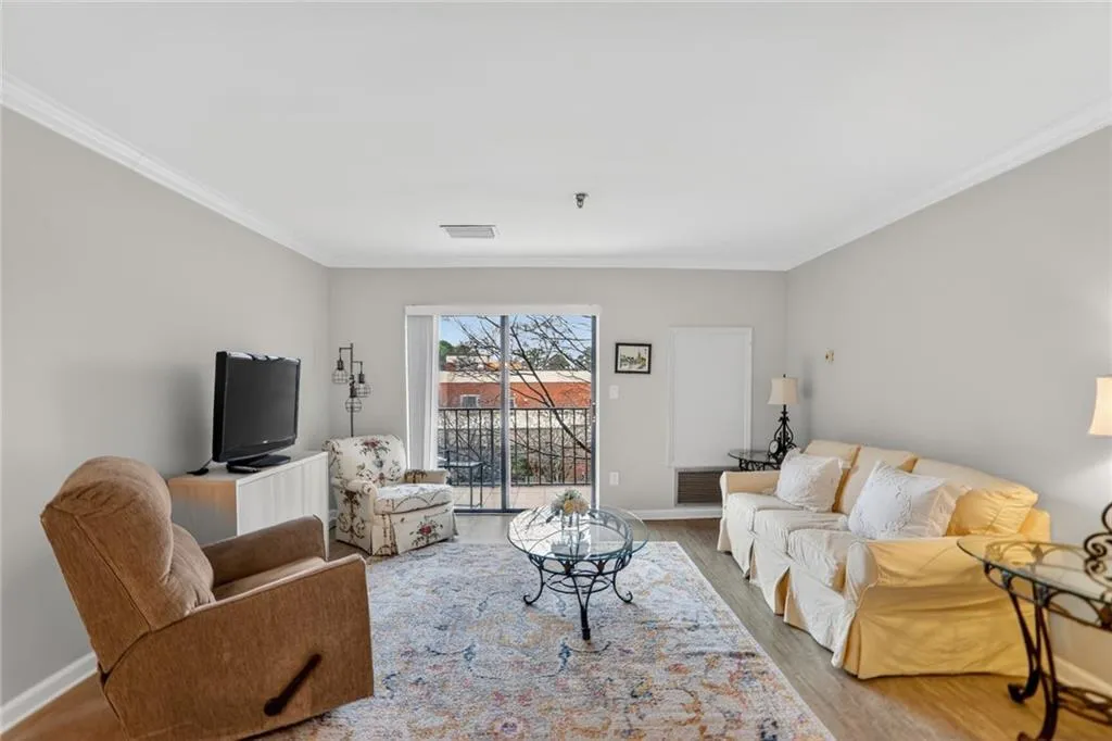 Living room featuring crown molding and wood finished floors
