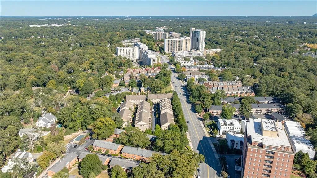 View of property location with nearby urban area and a heavily wooded area View of property location with nearby urban area and a heavily wooded area