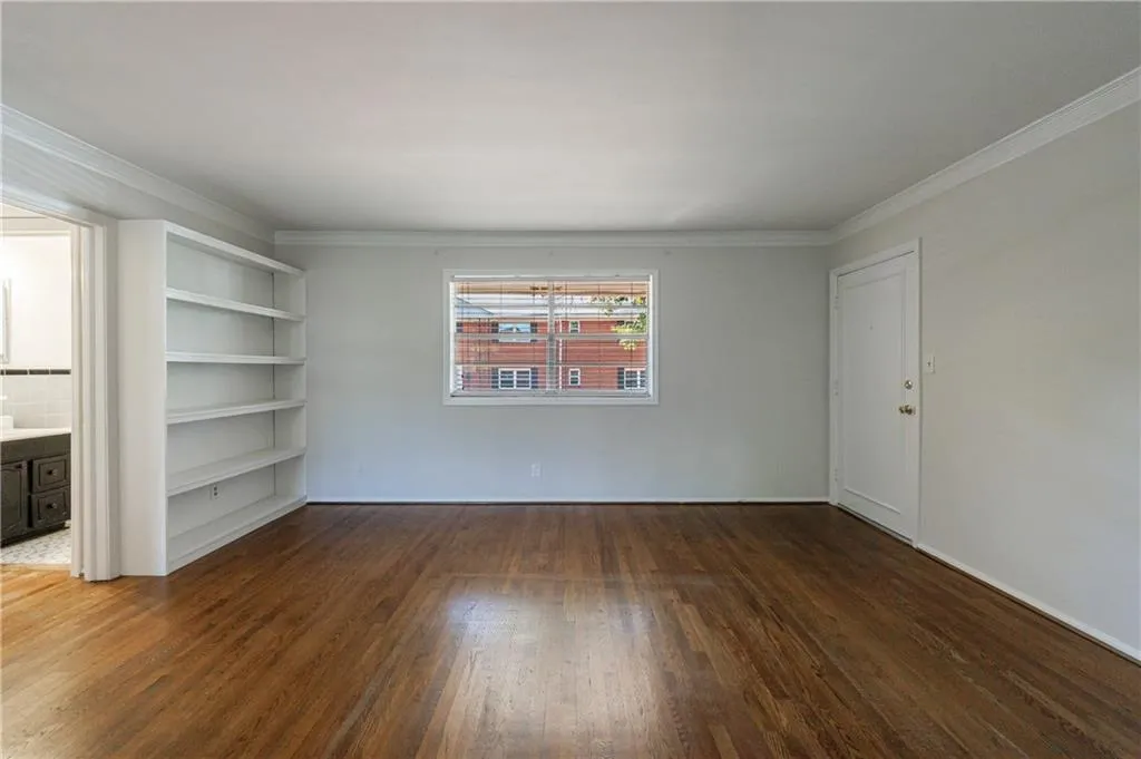 Empty room with ornamental molding and dark wood-type flooring Empty room with ornamental molding and dark wood-type flooring