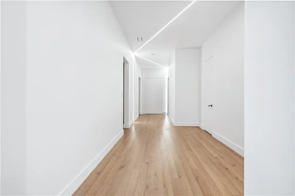 Hallway featuring light wood-style floors and baseboards