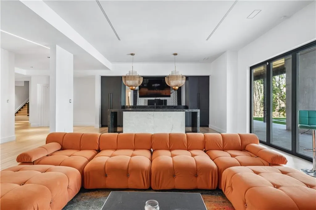 Living area featuring baseboards and stairway