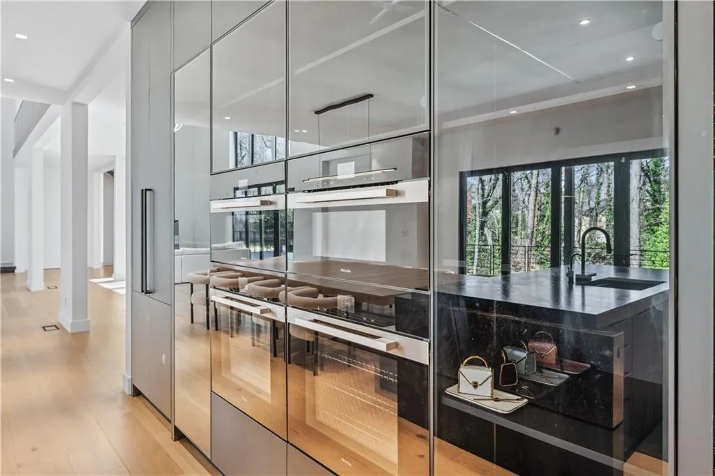 Kitchen with stainless steel double oven, recessed lighting, modern cabinets, light wood-style flooring, and plenty of natural light
