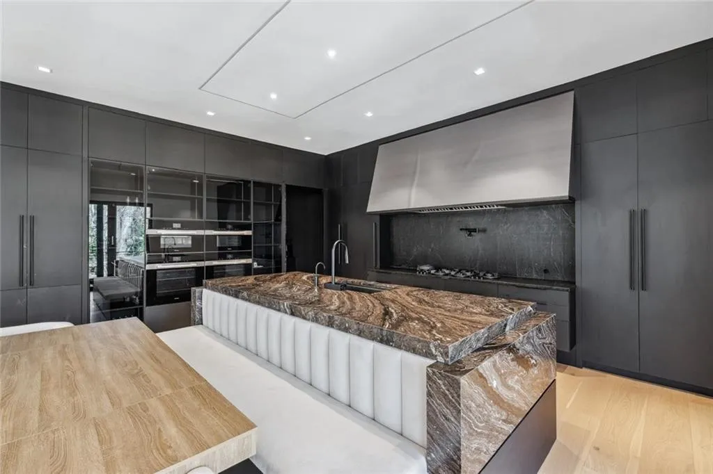 Kitchen with modern cabinets, dark cabinetry, stainless steel double oven, multiple ovens, and recessed lighting
