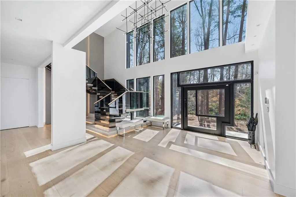 Foyer with light wood-style flooring and a high ceiling