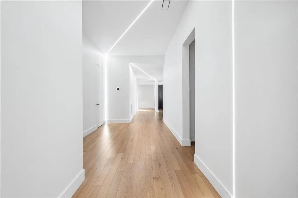 Hall featuring light wood-style floors and baseboards
