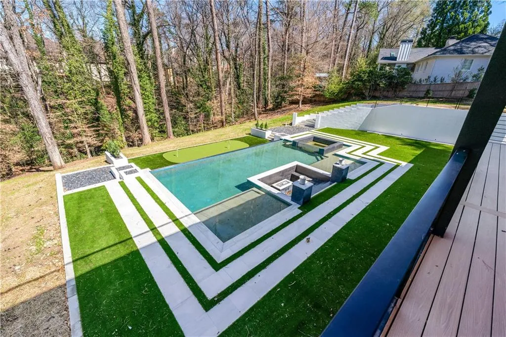 View of swimming pool with a patio and a putting green