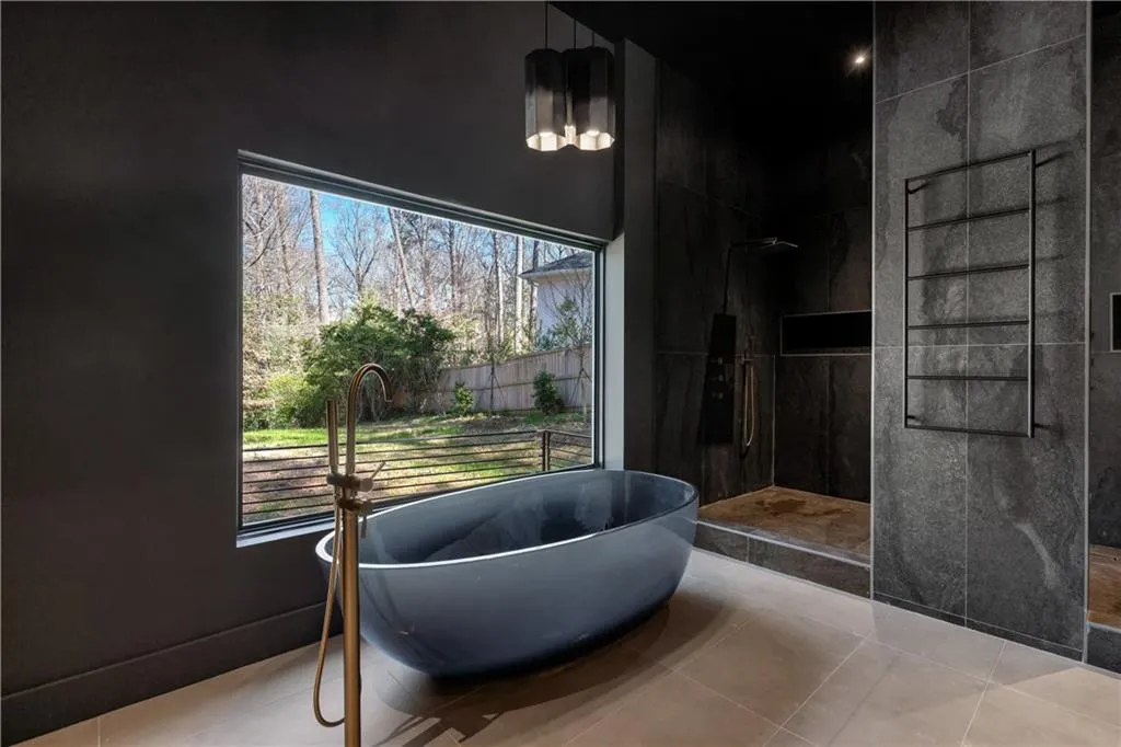 Bathroom featuring a freestanding tub, a walk in shower, and tile patterned floors