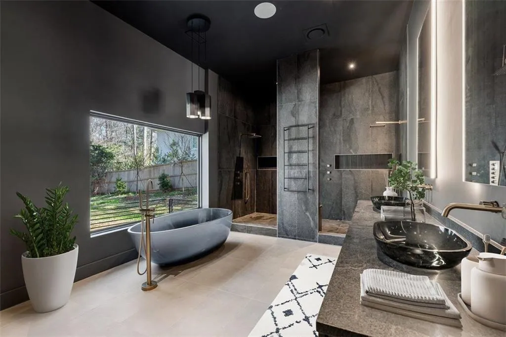 Full bathroom featuring a soaking tub, double vanity, and a shower stall