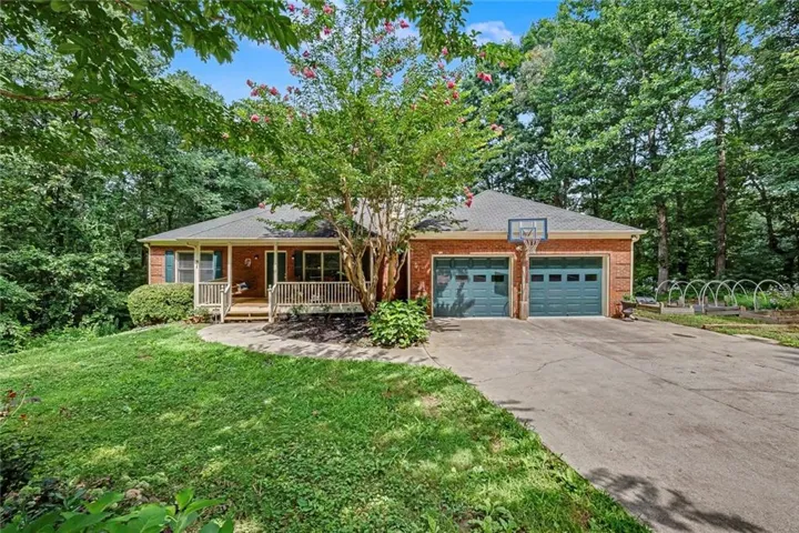 Private ranch home nestled on nearly 5 wooded acres with a welcoming front porch, and peaceful natural surroundings.