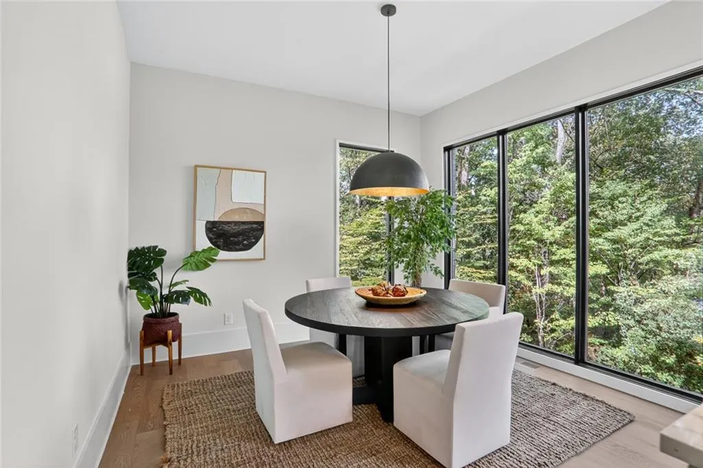 Casual dining area have gorgeous views of the woods.