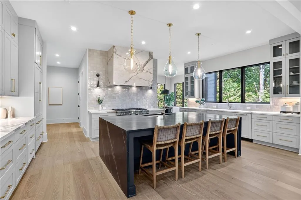 2 dishwashers, 2 sinks, 2 recycle bin cabinets, Quartzite water fall island, gorgeous Inset custom cabinets, handmade Morocan tile backsplash, walk-in pantry and coffee bar, lots of pull-out drawers and tons of natural sunlight with gorgeous wooded views!!!