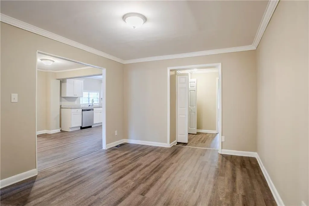 Spare room with crown molding, hardwood / wood-style flooring, and sink
