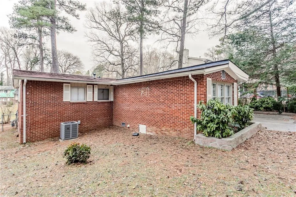 View of side of property featuring central AC unit