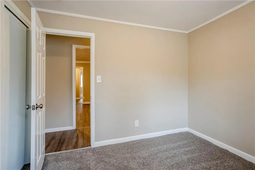 Empty room with carpet flooring and ornamental molding