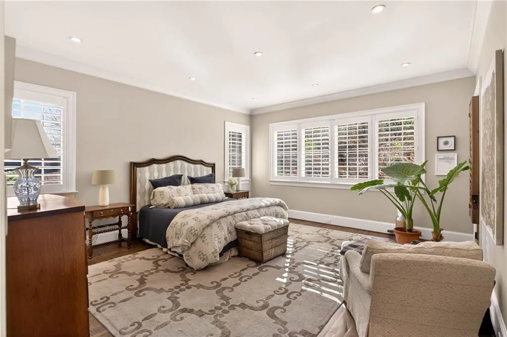 Bedroom featuring wood finished floors, ornamental molding, recessed lighting, and a baseboard radiator